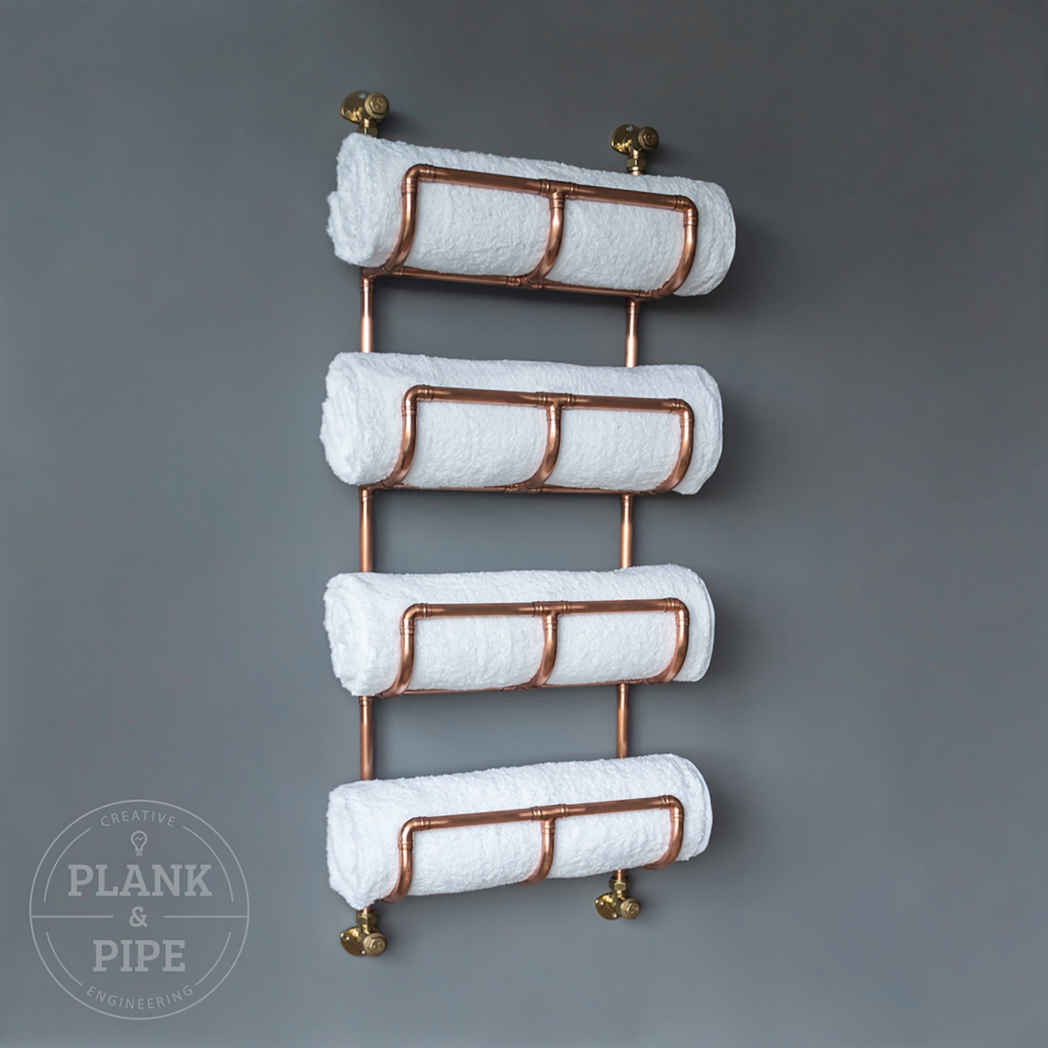Copper towel rack holding 4 towels 