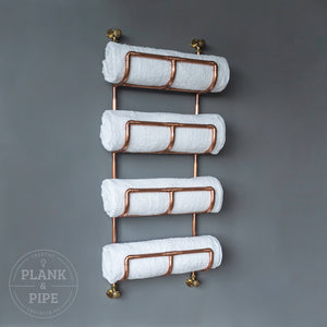 Copper towel rack holding 4 towels 
