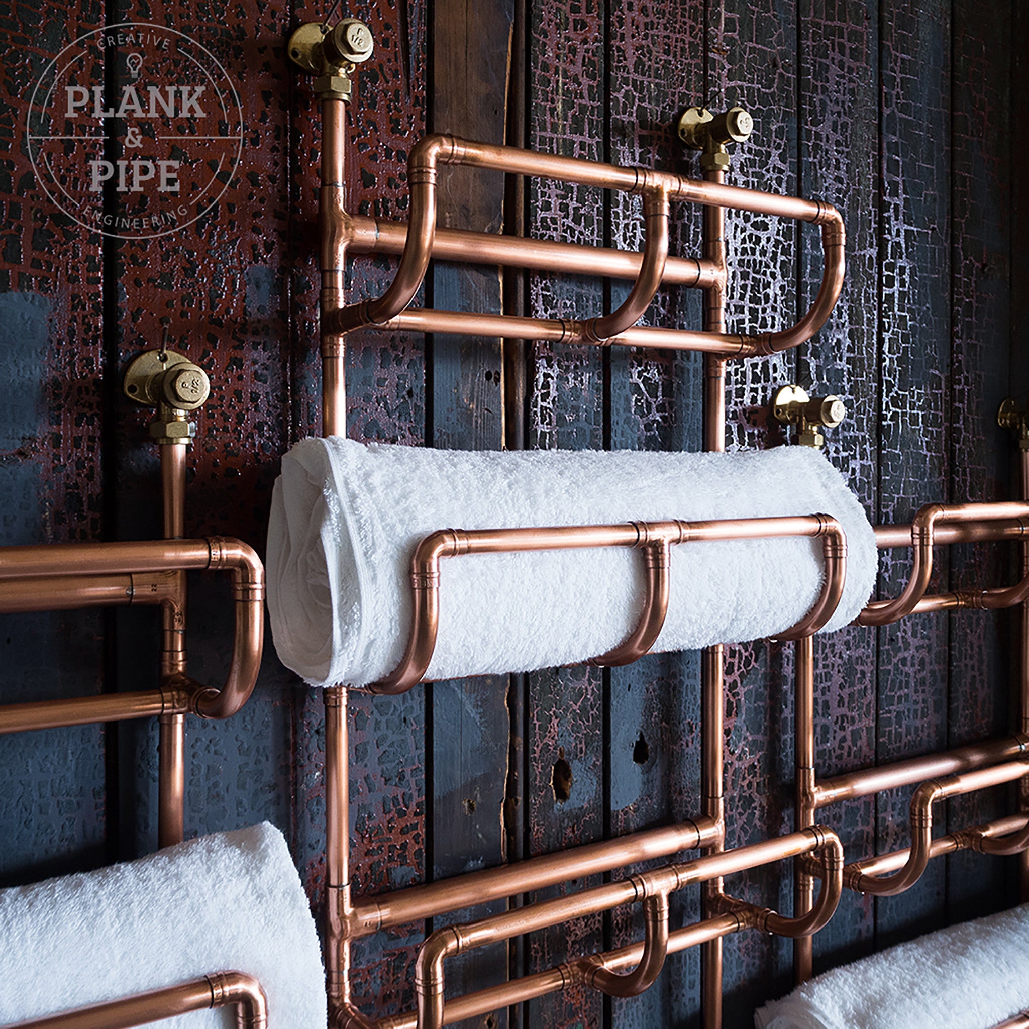 Close up of top of copper Towel Rack holding towels